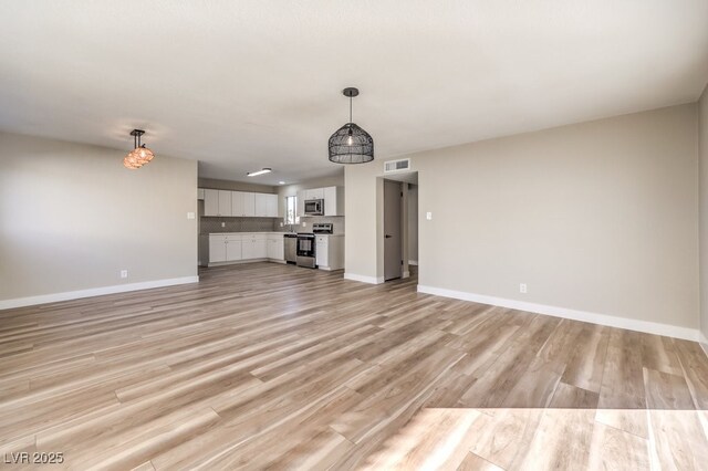 unfurnished living room with light hardwood / wood-style flooring