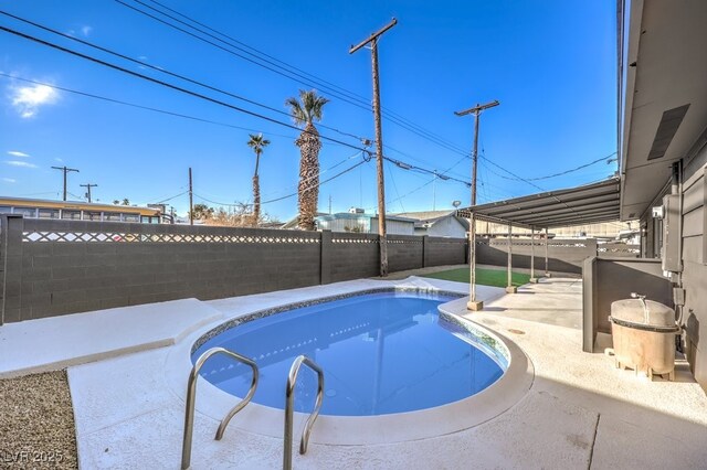 view of swimming pool with a patio