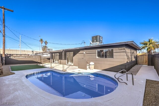 view of swimming pool featuring cooling unit and a patio