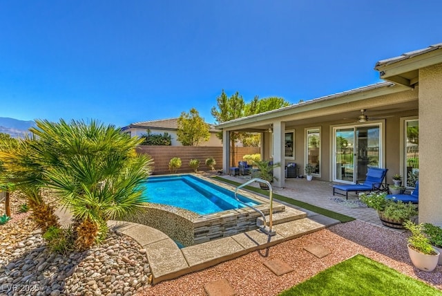 view of pool featuring ceiling fan and a patio area