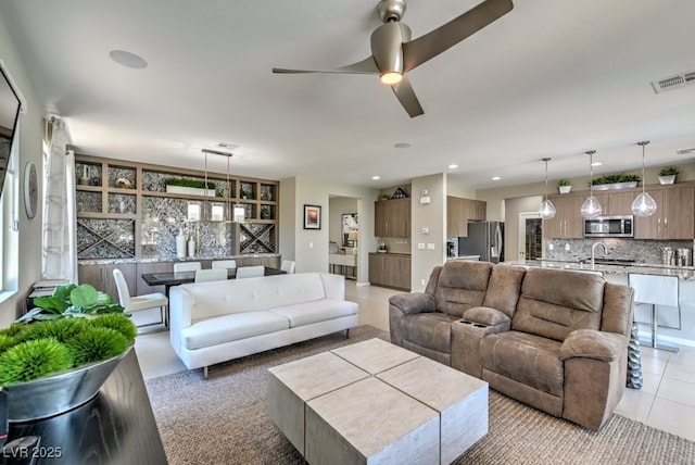 living room with ceiling fan and light tile patterned floors