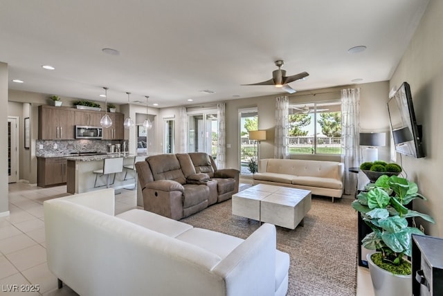 living room featuring ceiling fan and light tile patterned floors