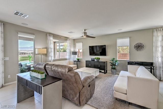 tiled living room with ceiling fan