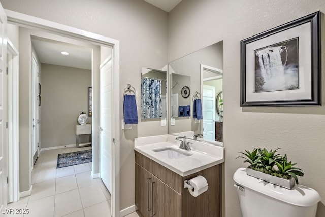 bathroom featuring tile patterned floors, vanity, and toilet