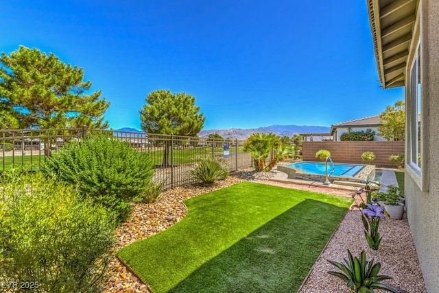 view of yard with a mountain view and a fenced in pool