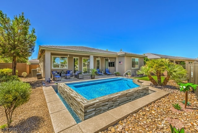 back of property featuring a fenced in pool, a patio area, central AC, and outdoor lounge area