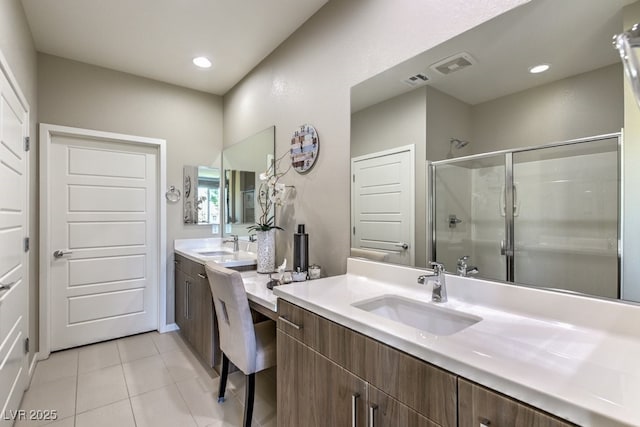 bathroom featuring walk in shower, vanity, and tile patterned flooring