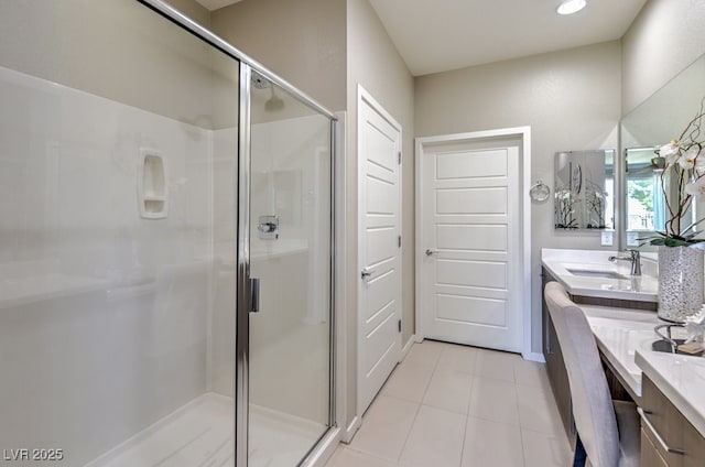 bathroom featuring vanity, tile patterned floors, and walk in shower