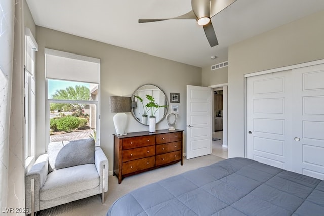 bedroom featuring ceiling fan, a closet, and light carpet