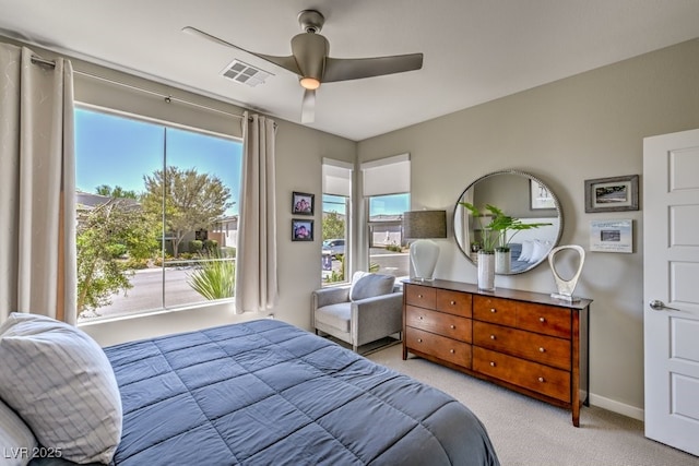 bedroom with ceiling fan and light colored carpet