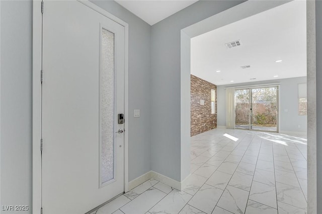 entrance foyer with marble finish floor, visible vents, and baseboards