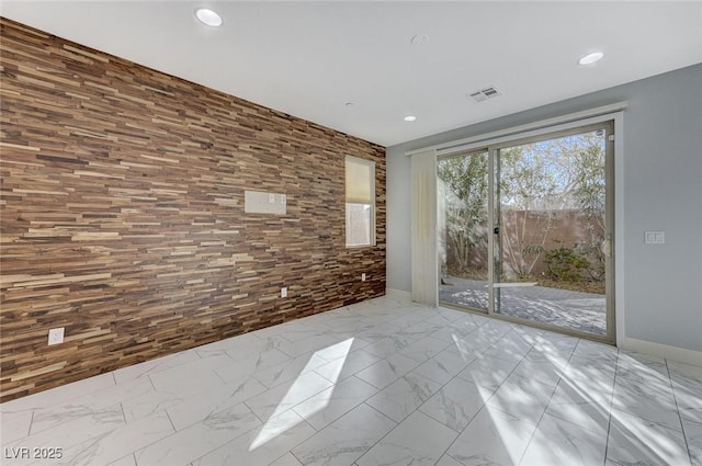 spare room with recessed lighting, marble finish floor, visible vents, and baseboards