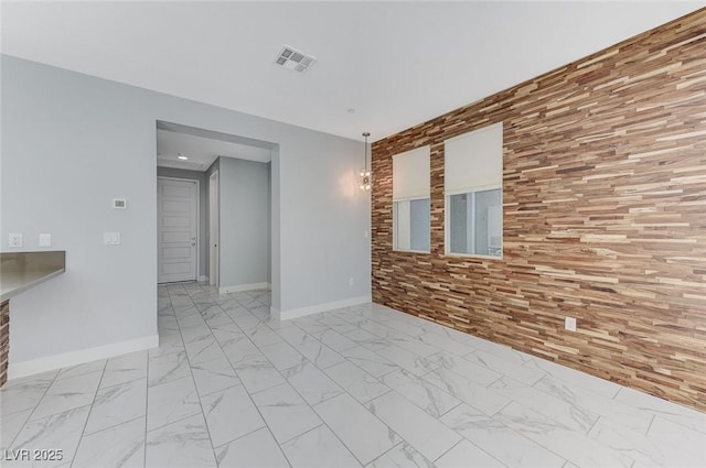 unfurnished room featuring marble finish floor, visible vents, and baseboards