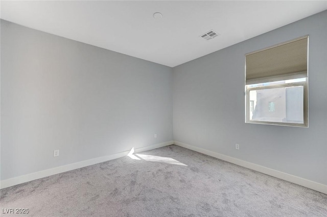 carpeted spare room with baseboards and visible vents