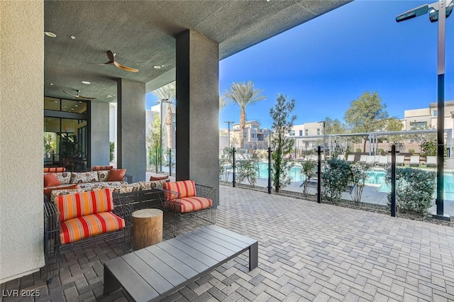 view of patio with outdoor lounge area and a community pool