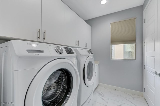 laundry area featuring cabinets and washer and clothes dryer