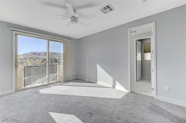 unfurnished room featuring carpet, visible vents, and baseboards