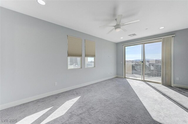 carpeted empty room featuring baseboards, visible vents, a ceiling fan, and recessed lighting