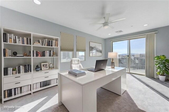 office area with light carpet and ceiling fan