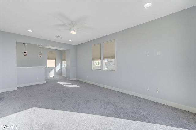 carpeted empty room featuring a ceiling fan, recessed lighting, visible vents, and baseboards