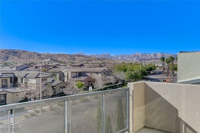 balcony featuring a residential view and a mountain view