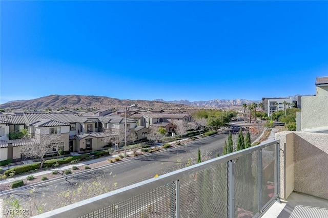 balcony featuring a residential view and a mountain view