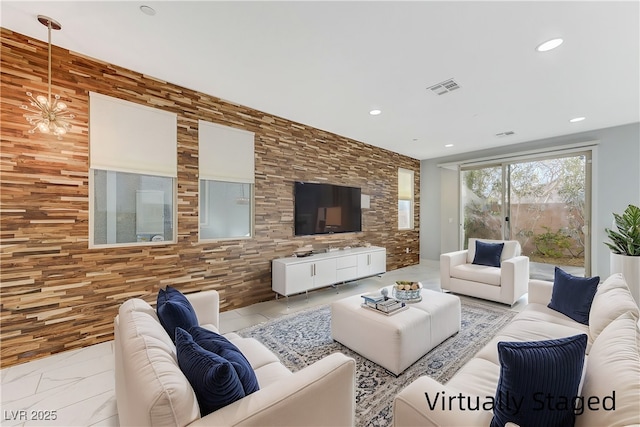 living area with recessed lighting, marble finish floor, visible vents, and an inviting chandelier