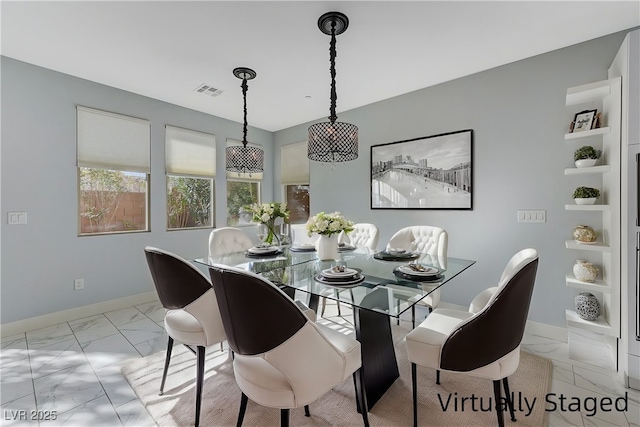 dining room with marble finish floor, visible vents, and baseboards