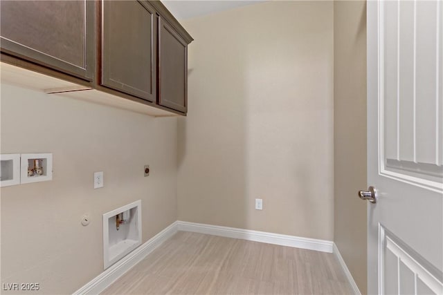 laundry area with cabinets, electric dryer hookup, light hardwood / wood-style floors, washer hookup, and gas dryer hookup