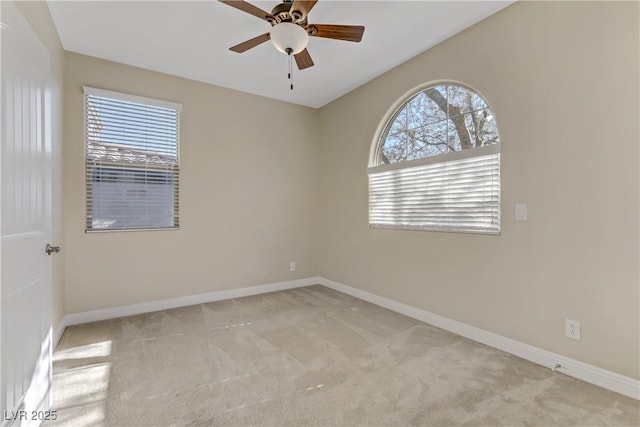 spare room featuring ceiling fan and light colored carpet