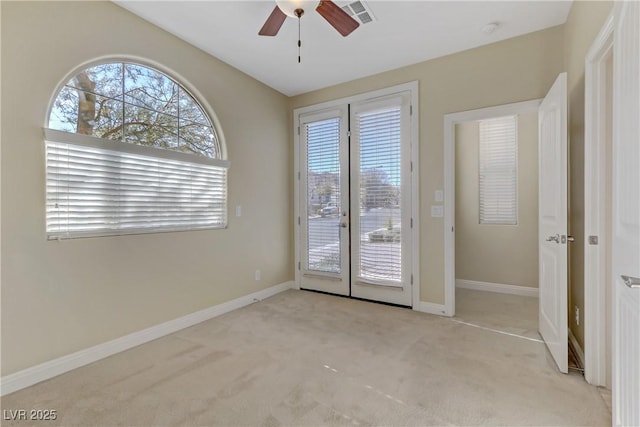 interior space featuring ceiling fan, light colored carpet, and french doors