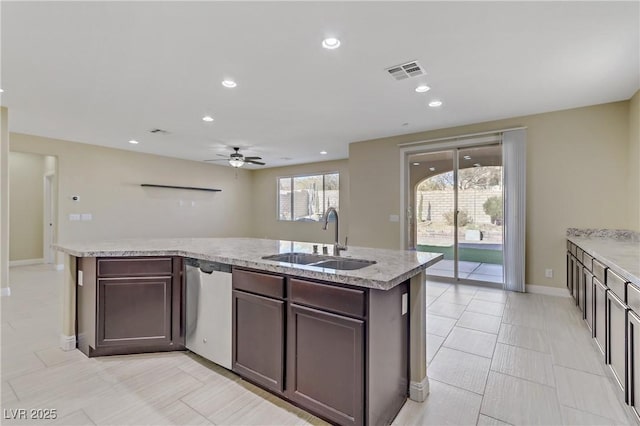 kitchen with ceiling fan, stainless steel dishwasher, sink, dark brown cabinetry, and a kitchen island with sink