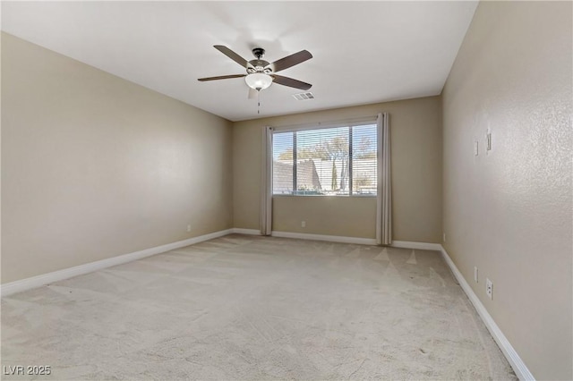 unfurnished room with ceiling fan and light colored carpet