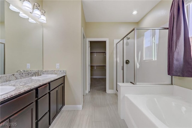 bathroom with shower with separate bathtub and vanity