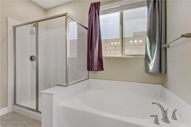 bathroom featuring wood-type flooring and plus walk in shower