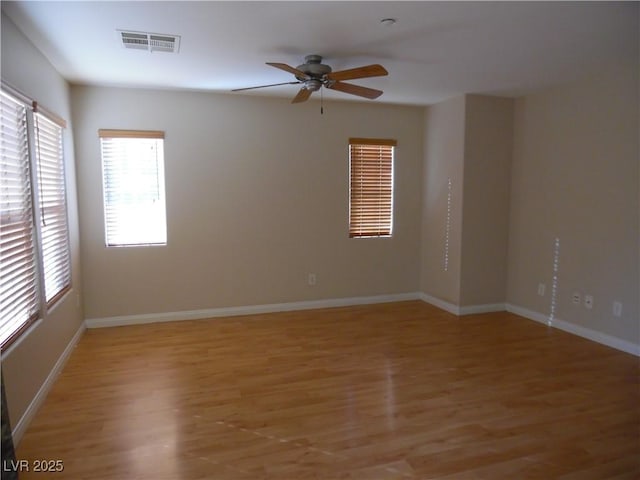 spare room with wood-type flooring and ceiling fan