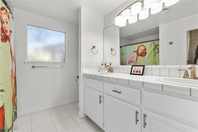 bathroom with tile patterned floors and vanity