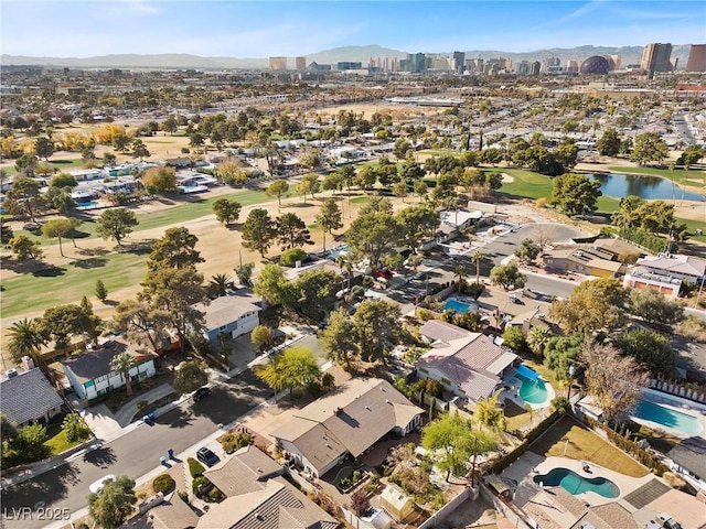 birds eye view of property with a water and mountain view