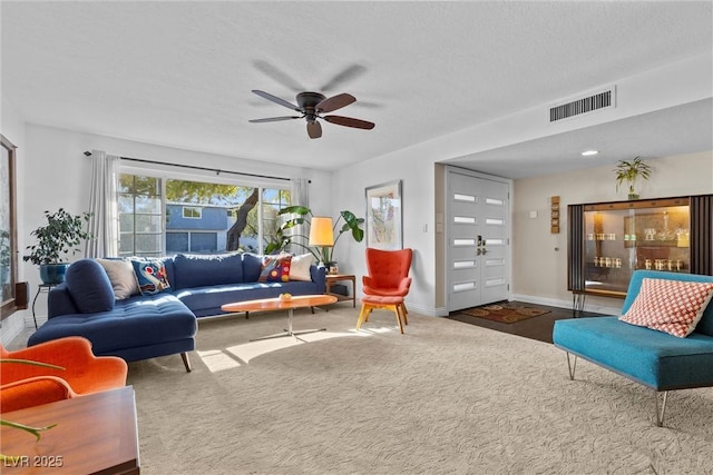 living room with ceiling fan and carpet floors