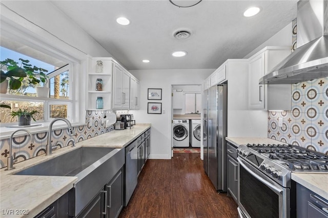 kitchen featuring appliances with stainless steel finishes, decorative backsplash, extractor fan, and white cabinetry