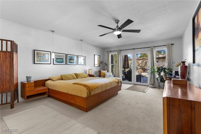 bedroom with ceiling fan, access to exterior, light colored carpet, french doors, and a textured ceiling