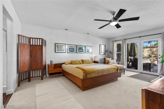 carpeted bedroom featuring ceiling fan, a textured ceiling, and access to outside