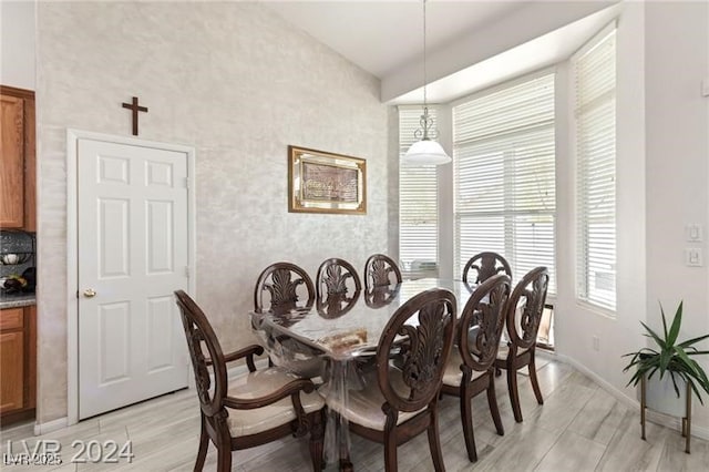 dining space featuring lofted ceiling