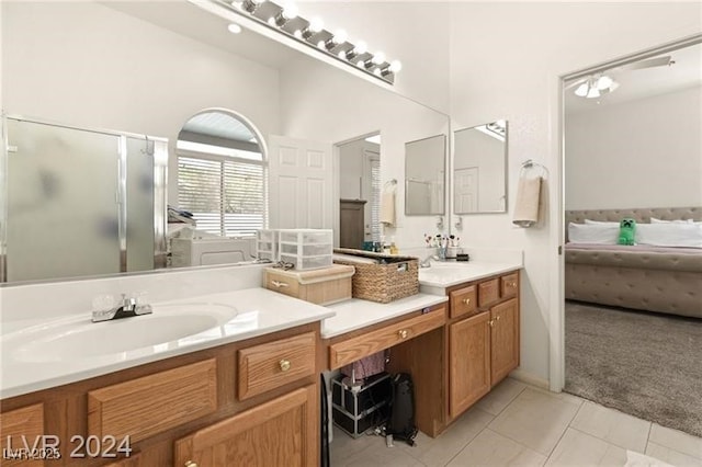 bathroom with vanity, tile patterned flooring, and a shower with door