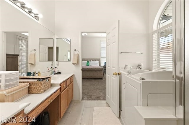 bathroom featuring vanity, washer / dryer, and tile patterned flooring