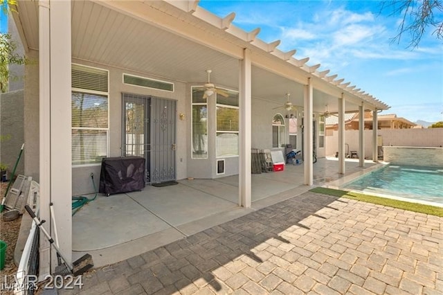 exterior space with ceiling fan and a fenced in pool