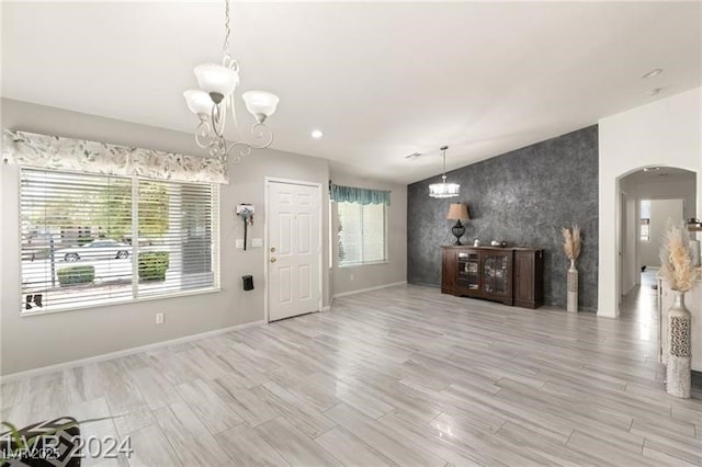 unfurnished living room featuring a chandelier and a healthy amount of sunlight