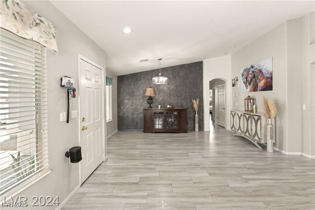 hallway with a chandelier