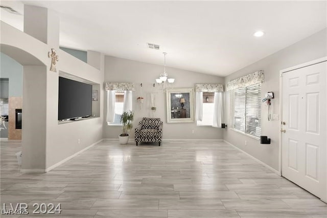 entryway featuring a chandelier and lofted ceiling