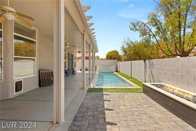 view of pool with ceiling fan and a patio